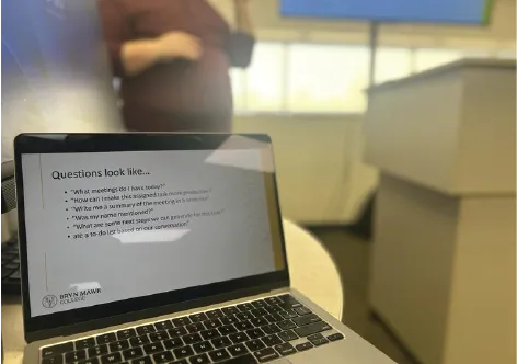 Photo shows Sean Keenan talking about Zoom AI Companion with questions to ask the companion on a computer screen