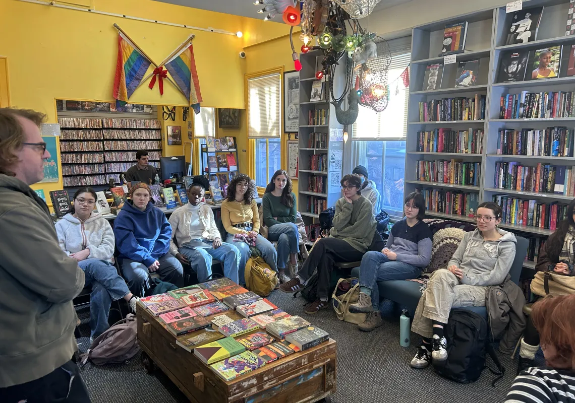 Students sitting in Giovanni's Room Bookstore.