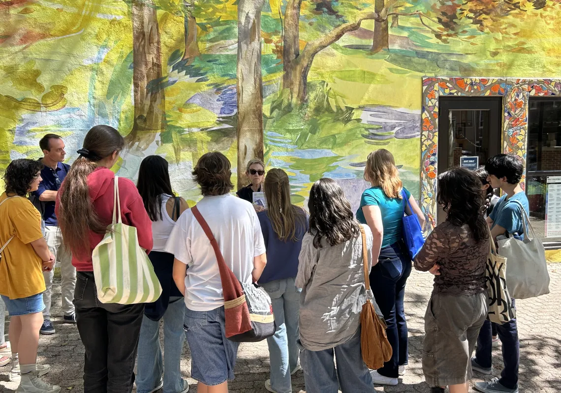 Students looking at a colorful mural.