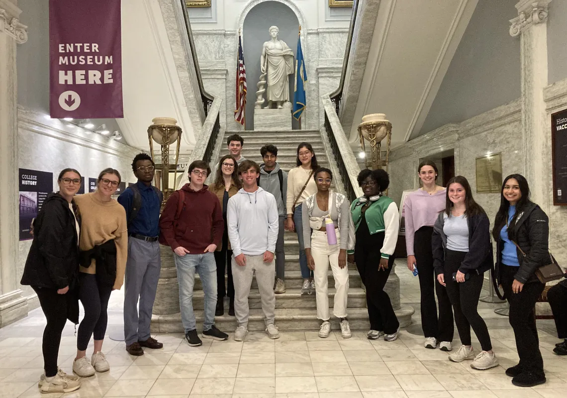 Students standing at bottom of stairwell at the Mutter Museum.