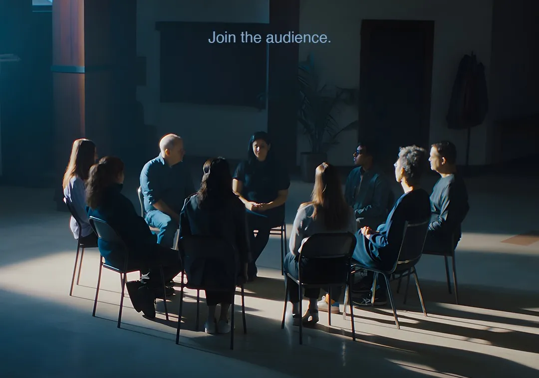 Film poster for We Are the Audience. A group of people sit in a chairs arranged in a circle.