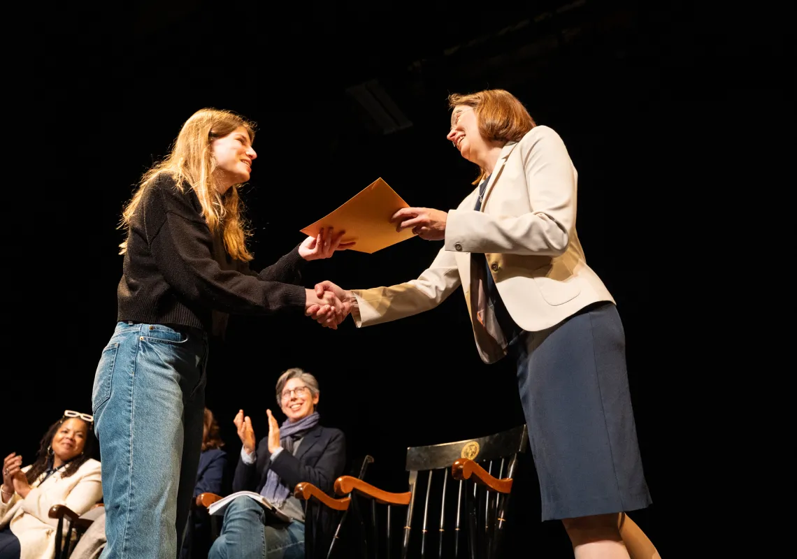 Wendy handing a student an award