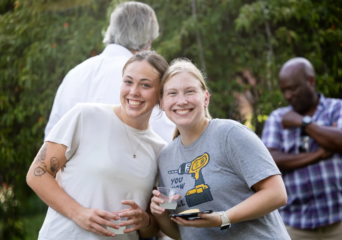 The women smiling and holding cups 