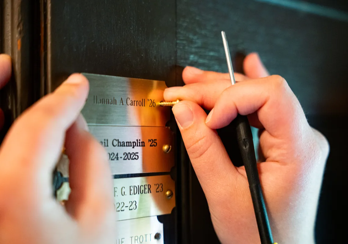 Hannah Carroll installs her brass nameplate