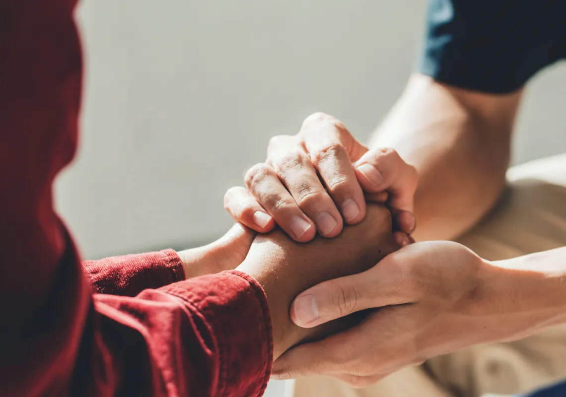 Two people holding hands