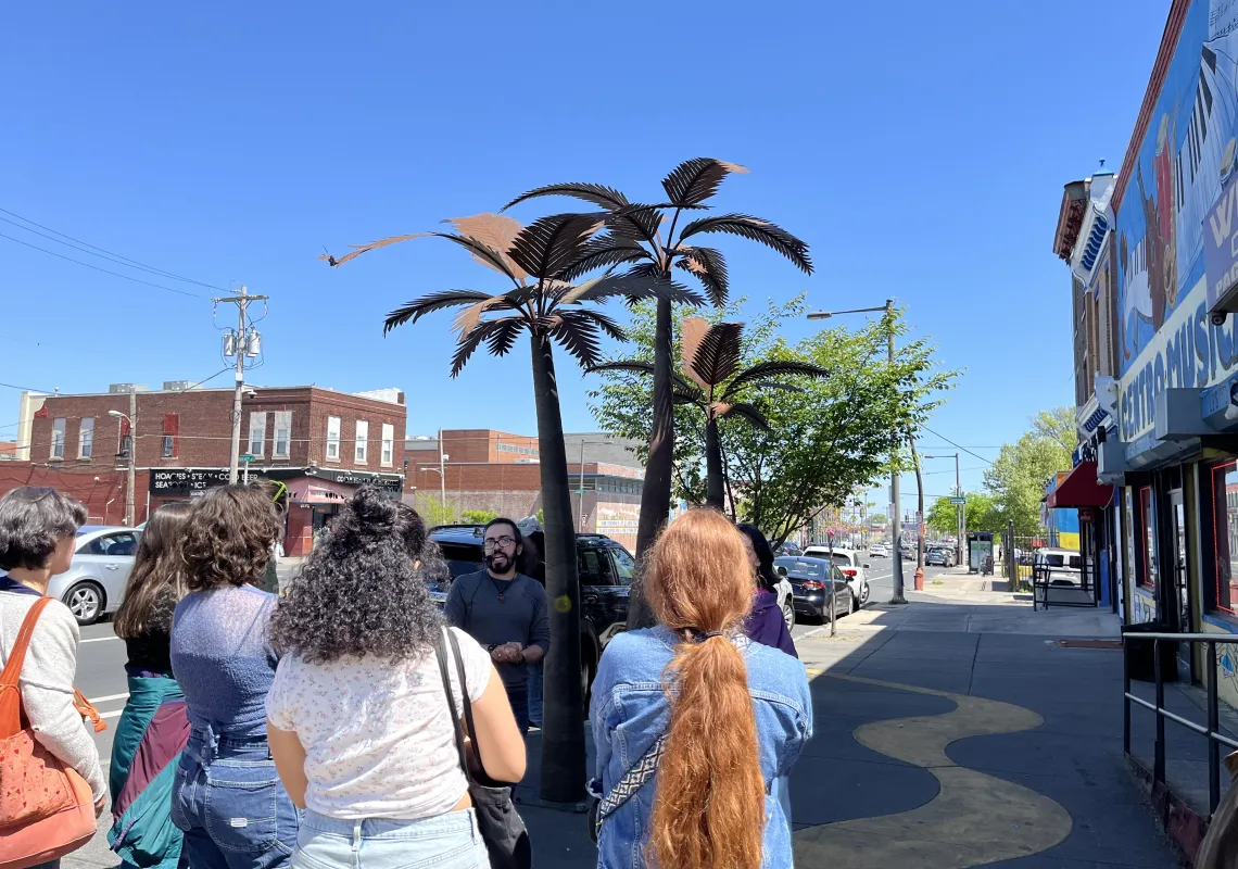 Taller Puertorriqueño - Image of Tri-Co Philly students outside of Taller Puertorriqueño, under a blue sky. Photo taken by Calista Cleary.