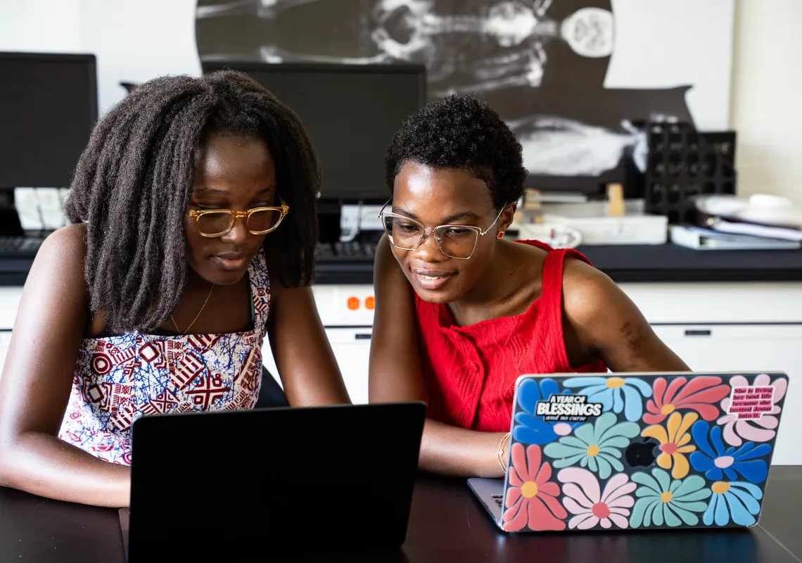 students looking at a laptop screen
