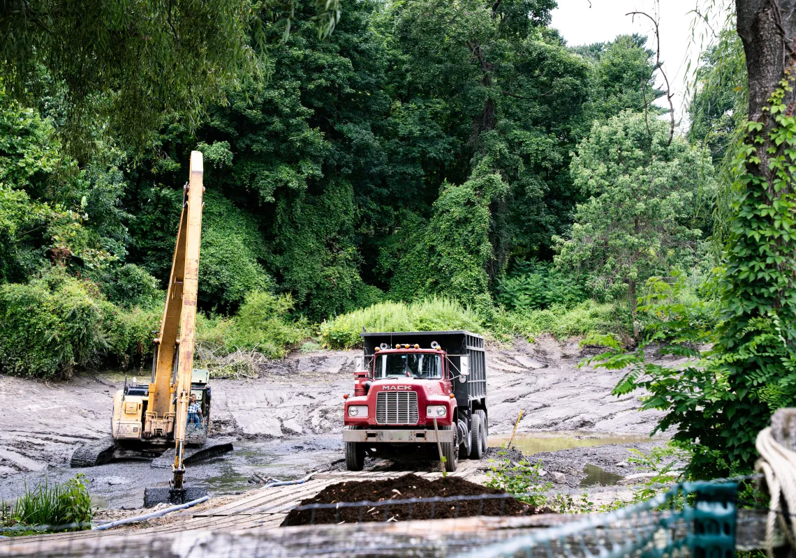heavy equipment working on dredging the on-campus lake