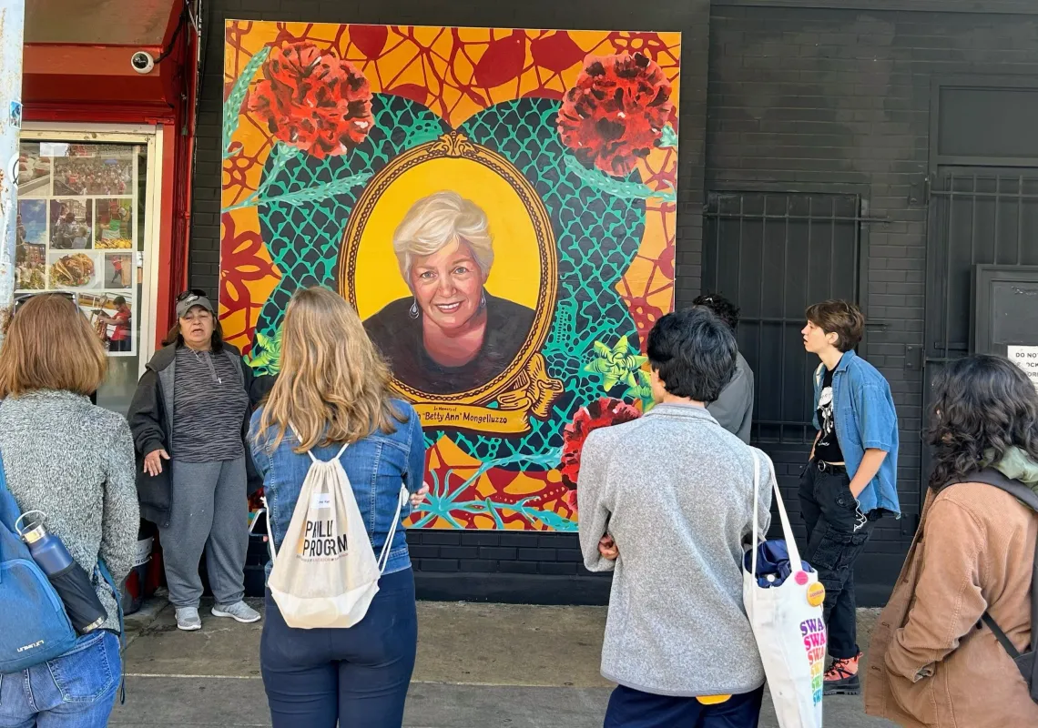 Photo of students look at mural.