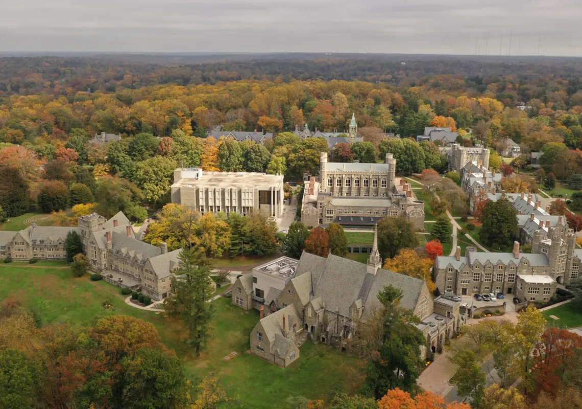 Drone view of the campus with trees changing color during Fall season