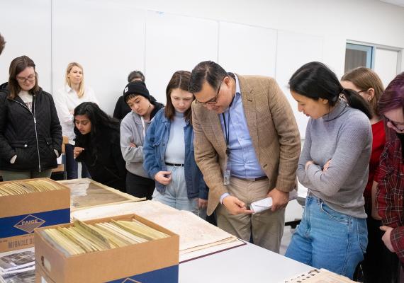 Students in 'The Philadelphia Mosaic' view material from Temple University's Urban Archives with Librarian 