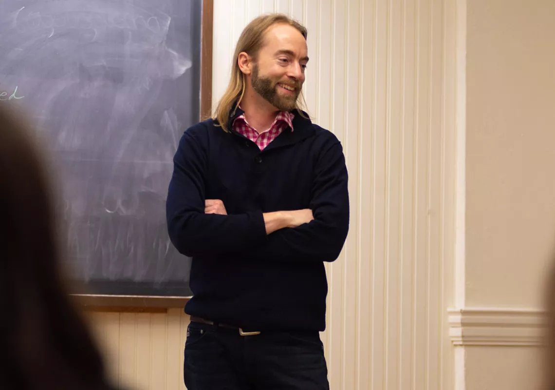 Joel Schlosser in classroom, engaging in research with students