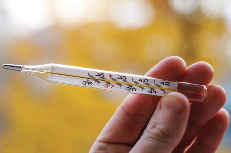 hand holding a mercury thermometer