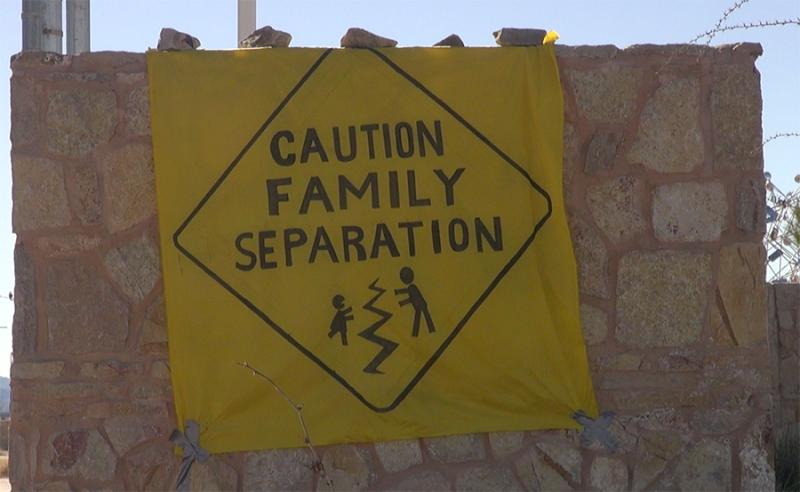 Protest sign displaying a drawing of a road sign, reading "Caution Family Seperation"
