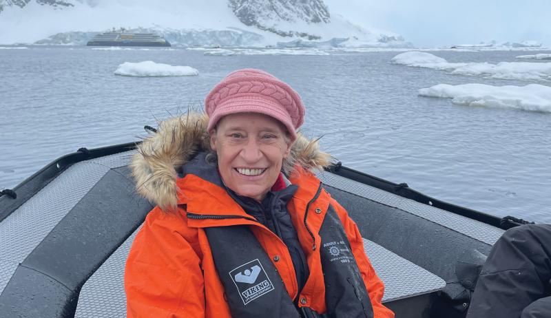 Kathi Atkinson sitting in a boat on icy water