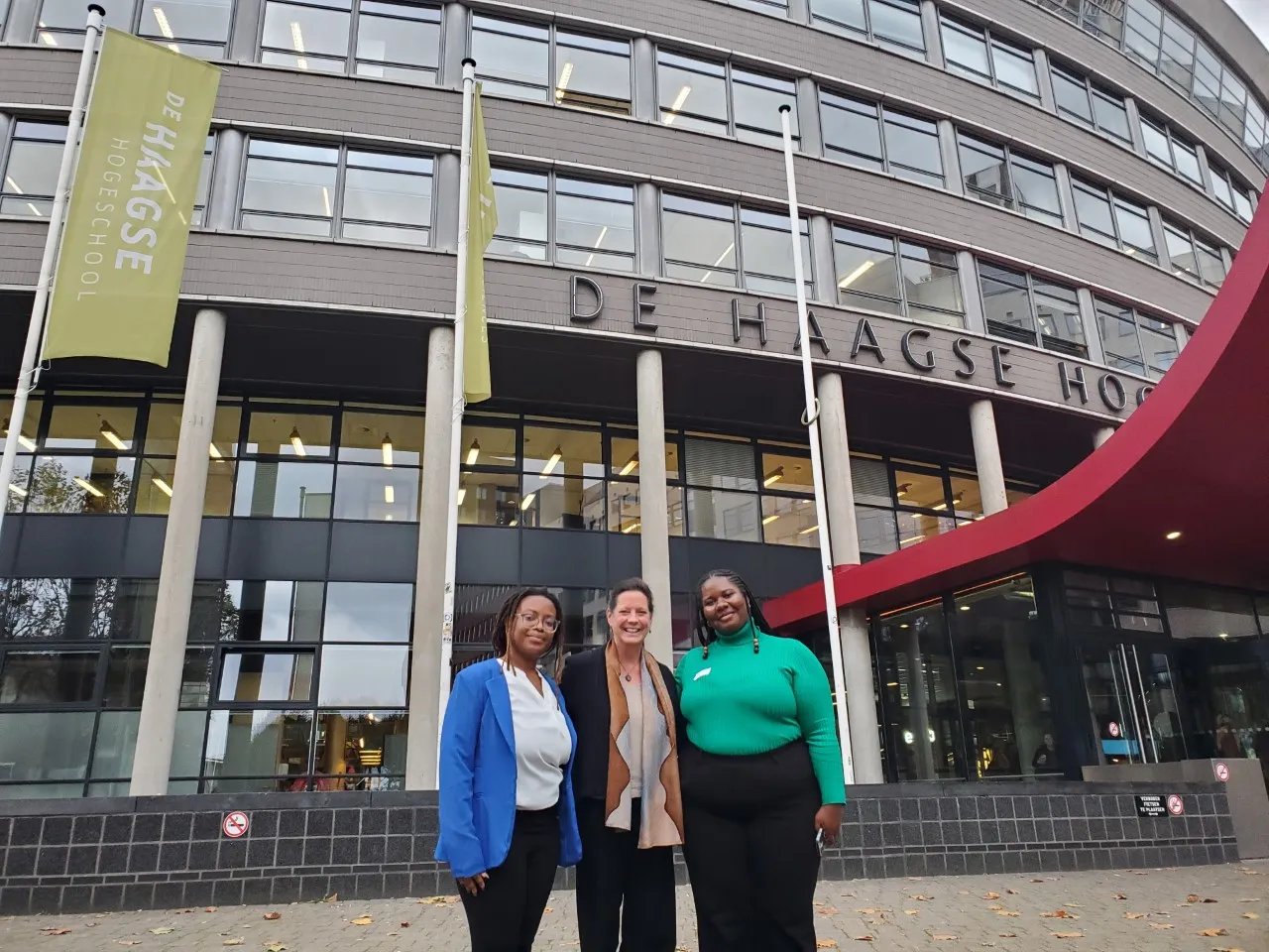 Alison Cook-Sahter, Khadijah Seay, and Ebony Graham standing in front of the Hague University in The Netherlands