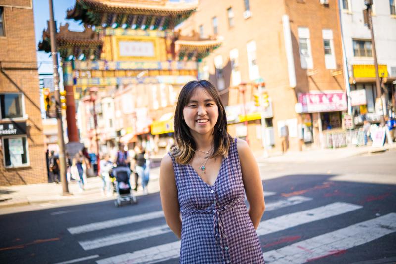Kaia Chau standing in front of the Philadelphia Chinatown Gates