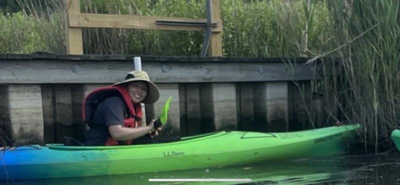 Student in a kayak in a wetland. 