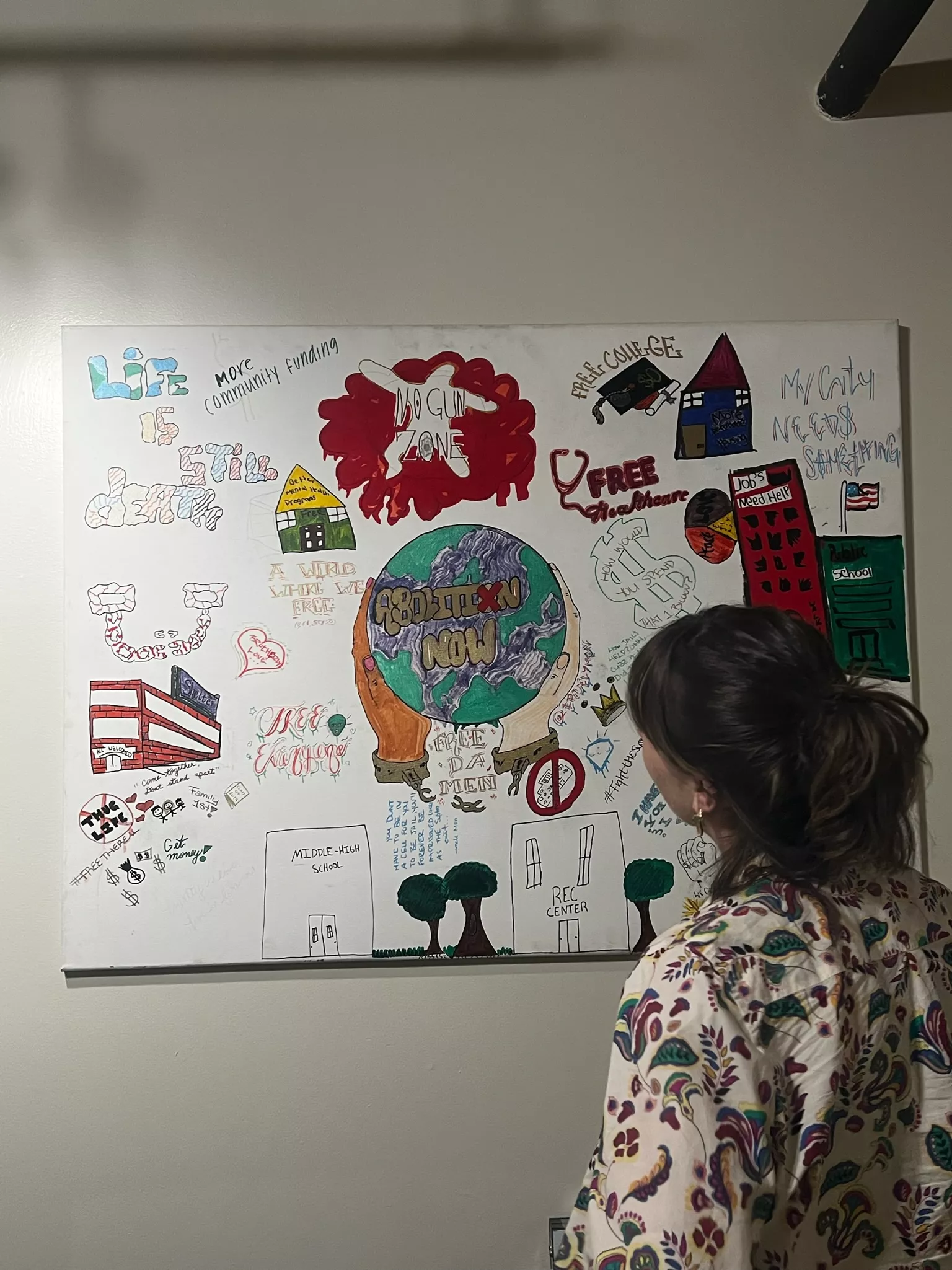 Kira admiring artwork on a wall