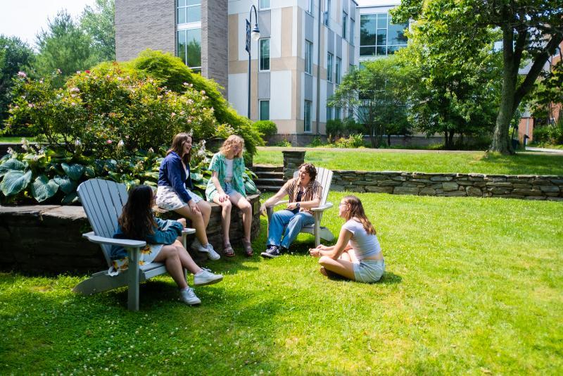 Students sitting in the Sunken Garden with New Dorm in the background
