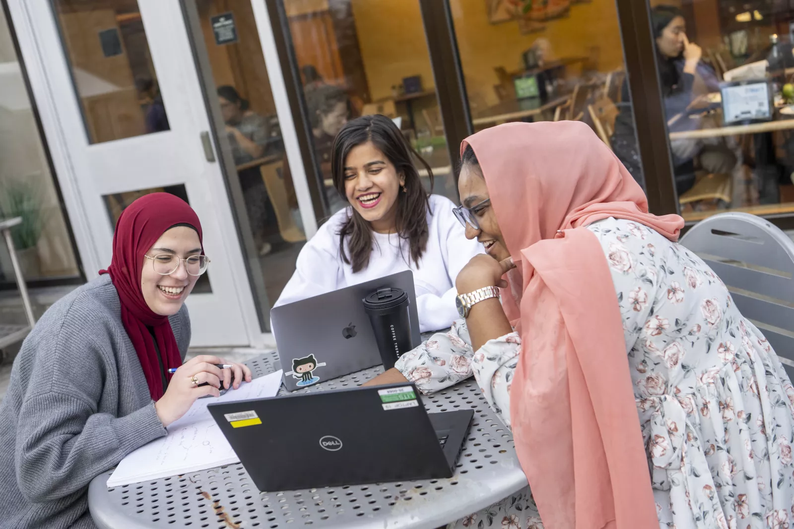 Students laughing in front of New Dorm Dining Hall