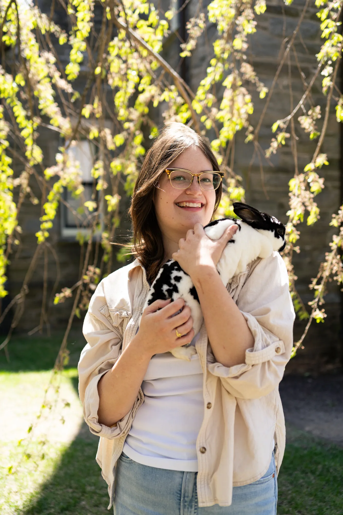 Brooke holding her pet bunny under the willow trees