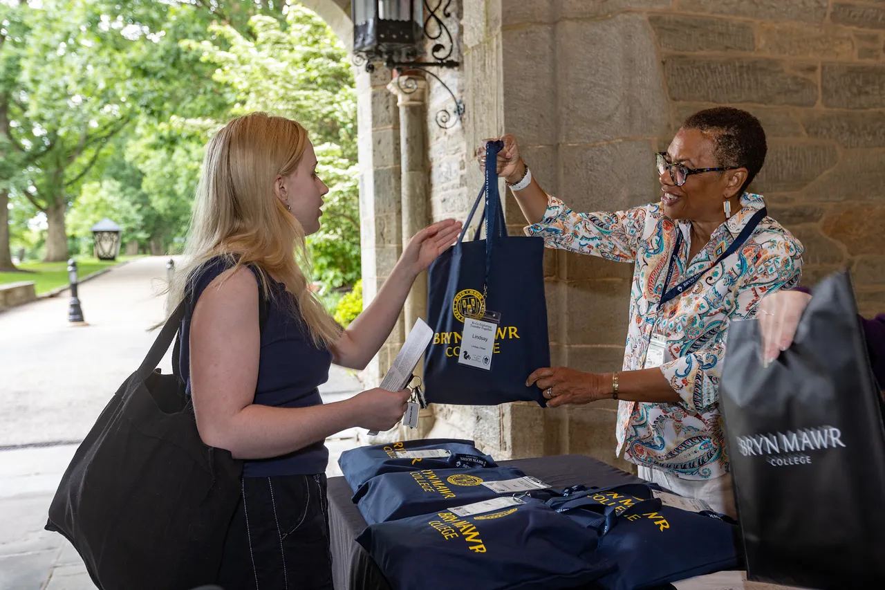 Bryn Mawr’s Chief Enrollment Officer Cheryl Lynn Horsey check's a student in.