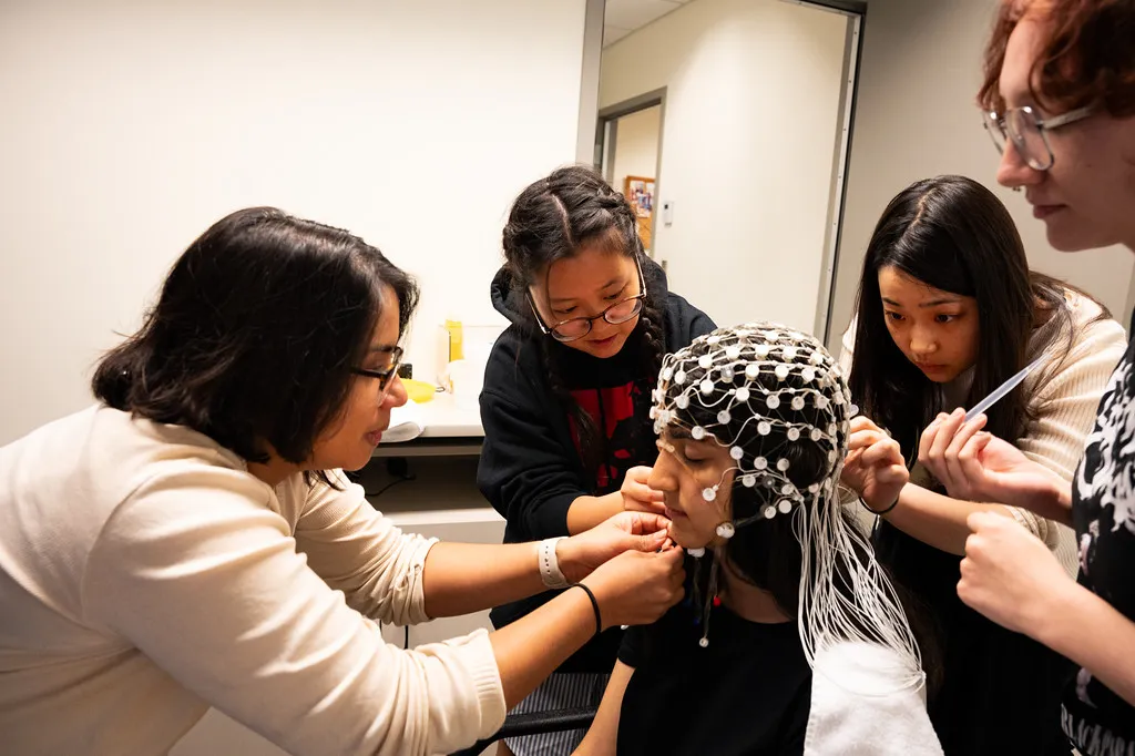 students and faculty work in the lab