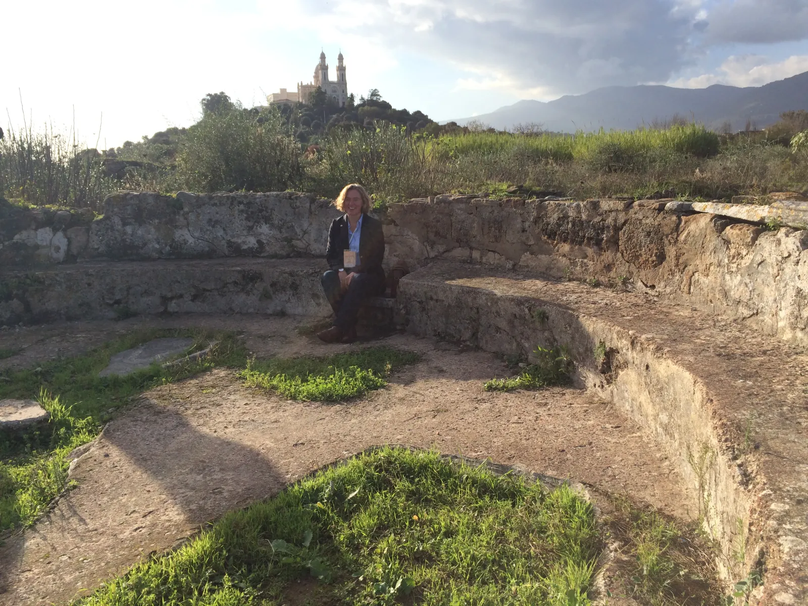 Catherine Conybeare sitting in the ruins of Augustine's Church