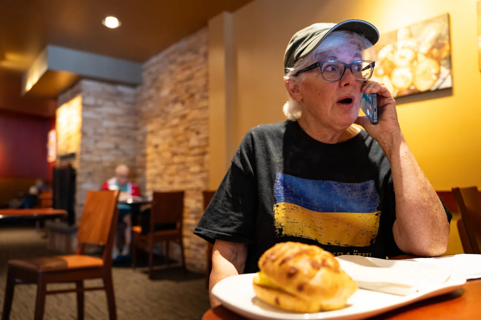 Barbara Miller ’75 on the phone in Panera