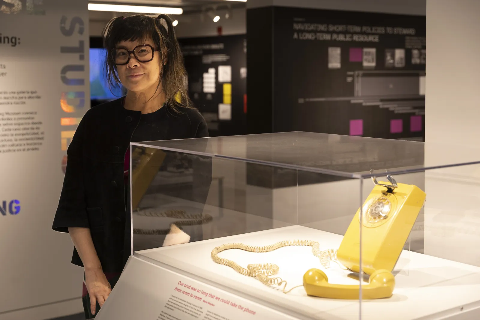 Lisa Yun Lee ’91 beside a rotary phone on display at the National Public Housing Museum