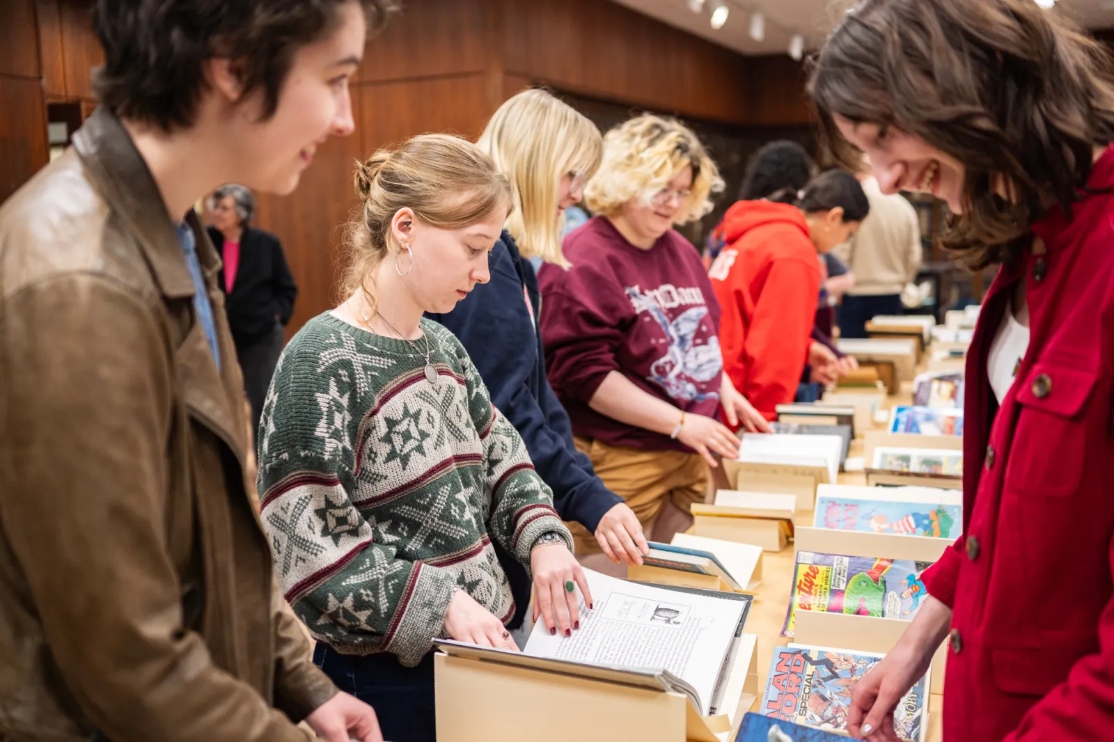 Students page through different versions of Moby Dick in Special Collections.