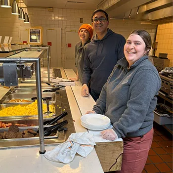 Staff helping to serve food at Midnight Breakfast 2025