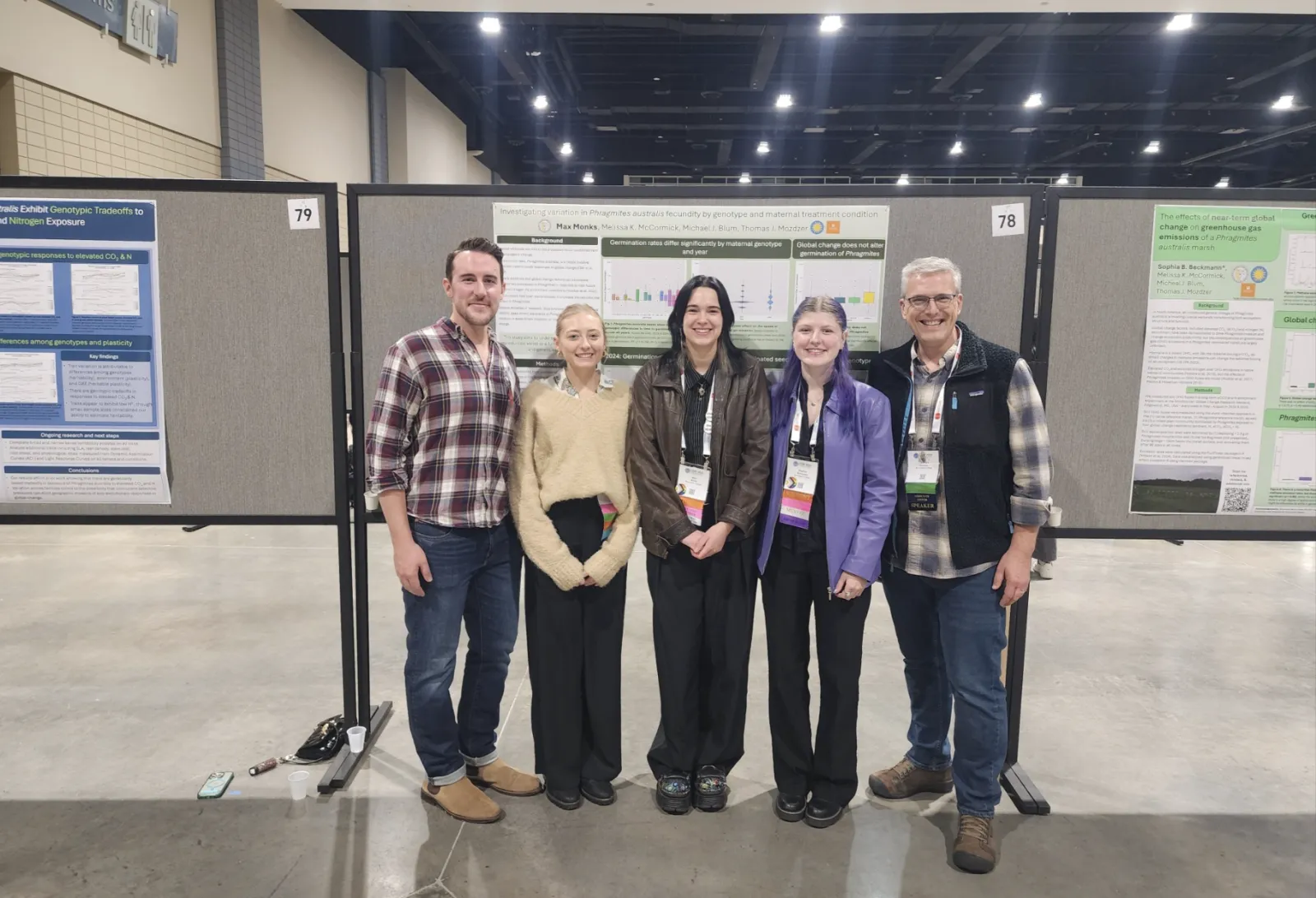 Max Monks at Conference with group in front of poster