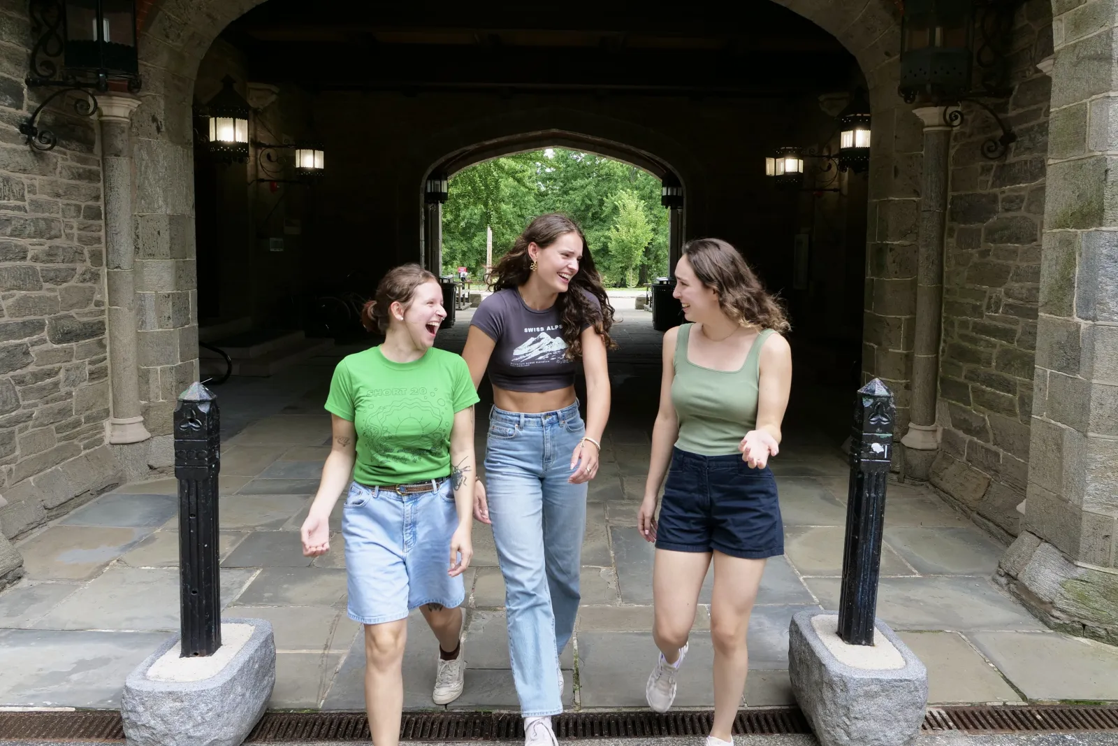 A trio of students walk between the friendship poles at Pem Arch. Photo by Helen Christ.