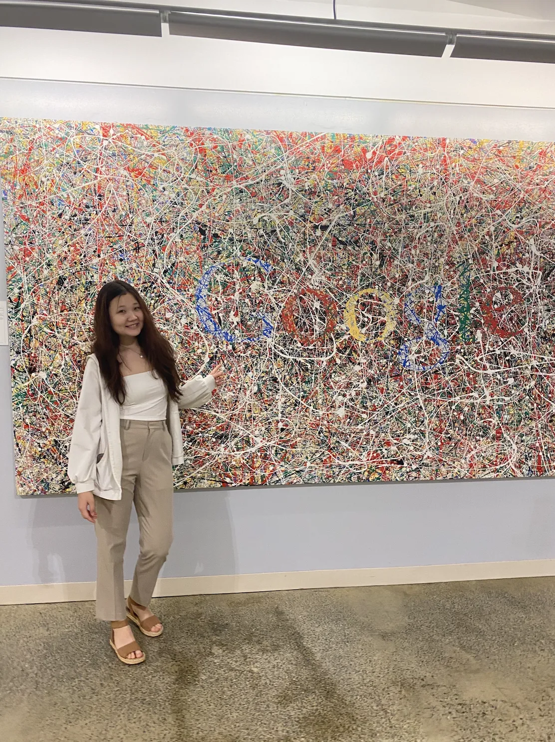 Saniya in front of a colorful Google sign