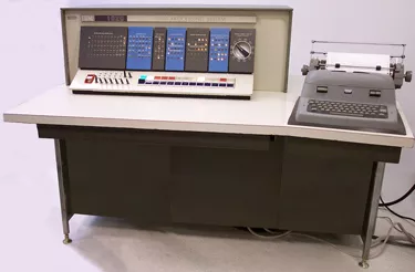 Old computer: typewriter and circuit board, no monitor.