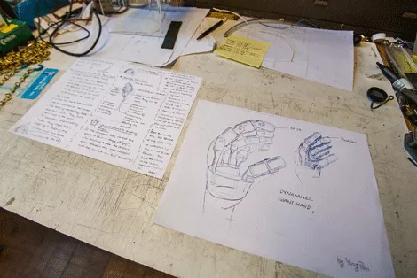drawings of a robotic hand on a table