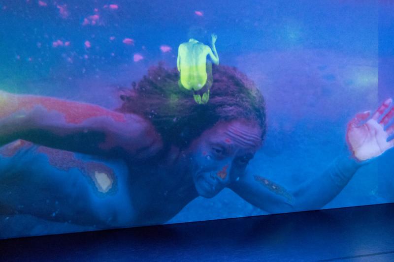 Image of woman underwater and a man dancing