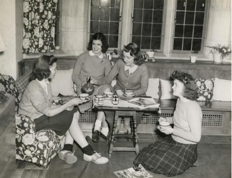 Unknown students from the 1960s cluster, having tea.