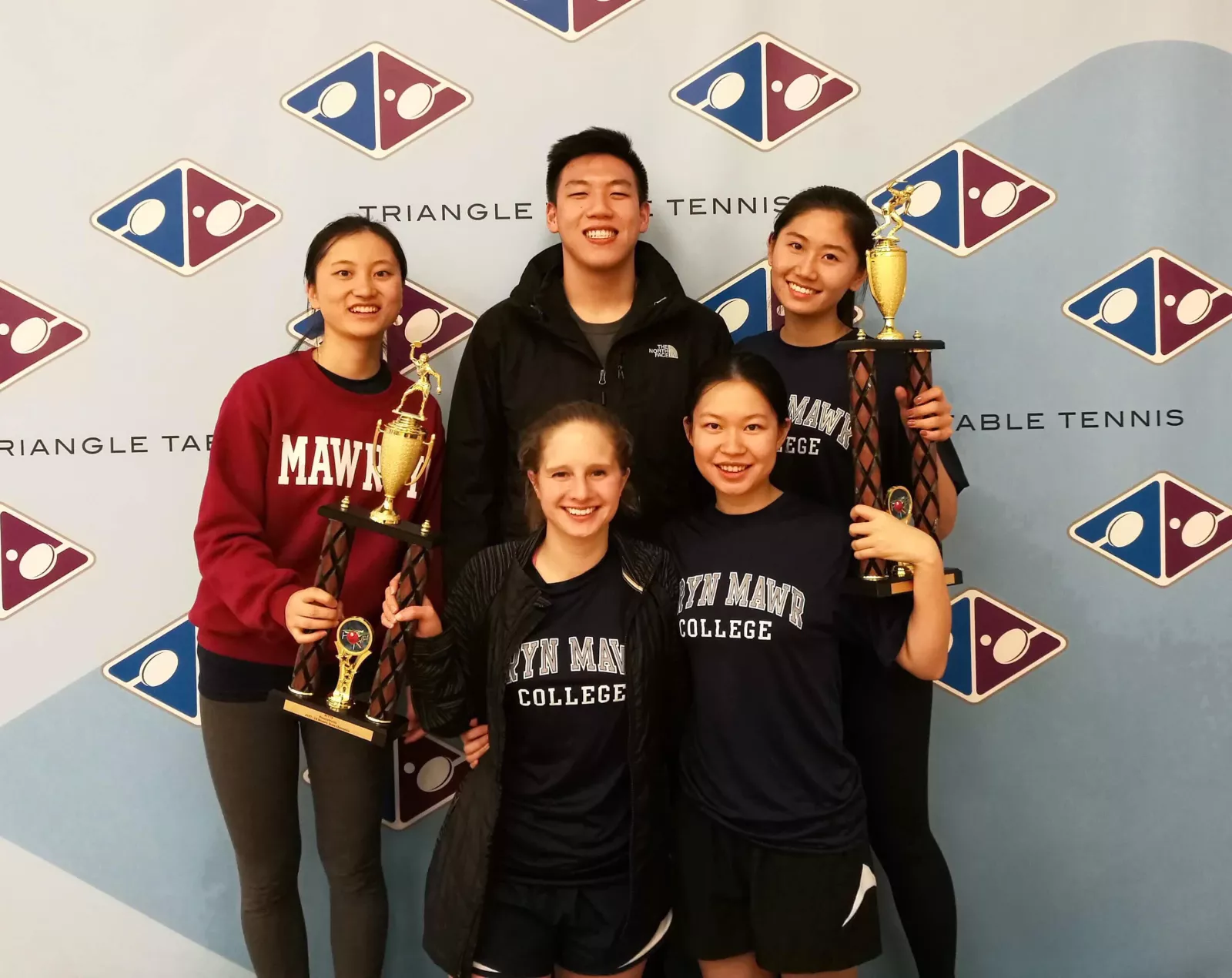ping pong team with trophy