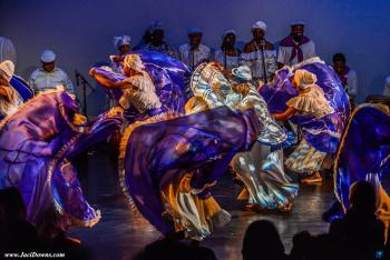 Dancers on stage in purple light