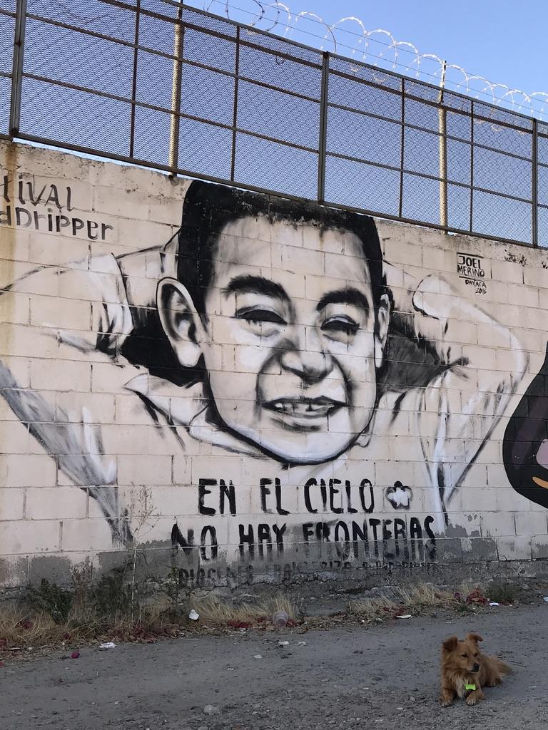 Mural of a child on border wall