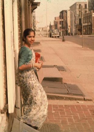 Saroja standing against a wall in Philadelphia, 1961