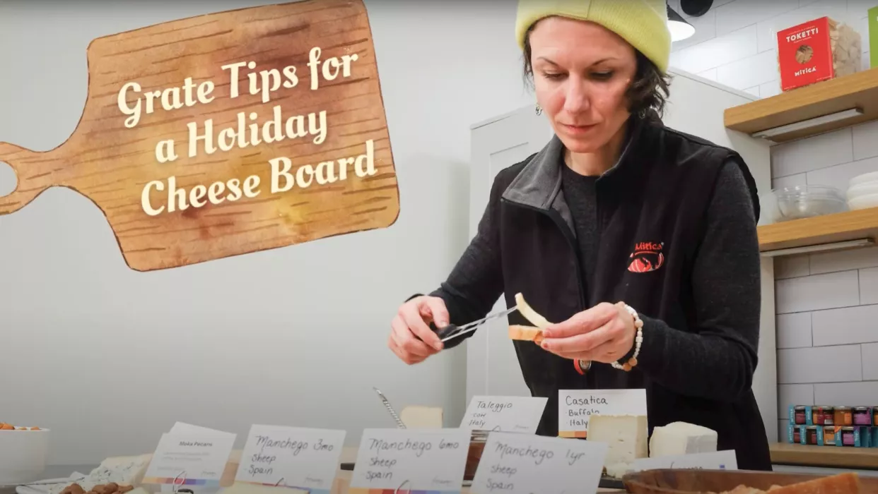 A photo of Mia Vergari spreading cheese on a cracker.